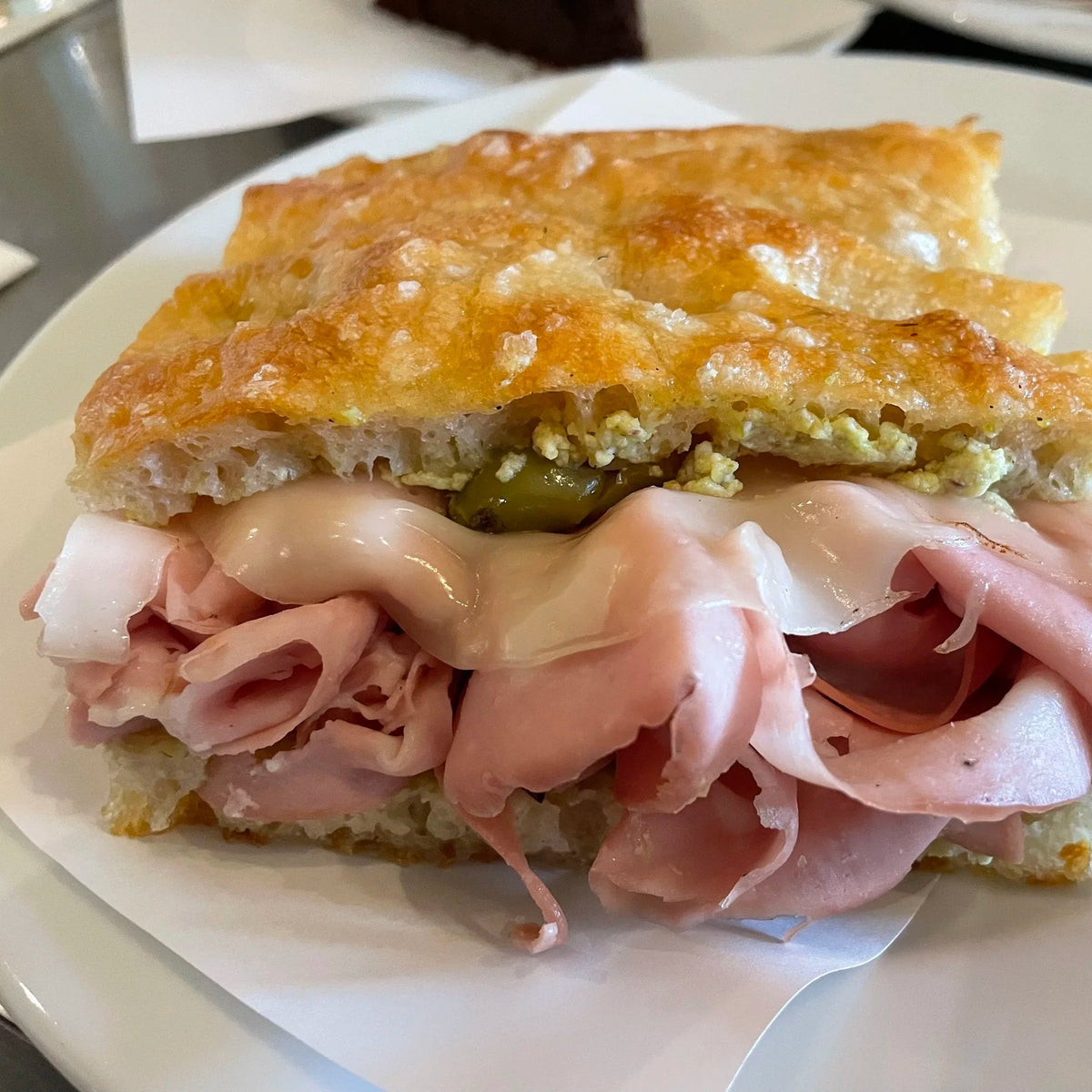 Mortadella + swiss focaccia with dijon mayo, mortadella, artichokes + swiss cheese + rocket