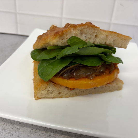 Vegan focaccia sandwich with red pesto, roast pumpkin, caramelised onion, baby spinach + vegan aioli (vegan/df)