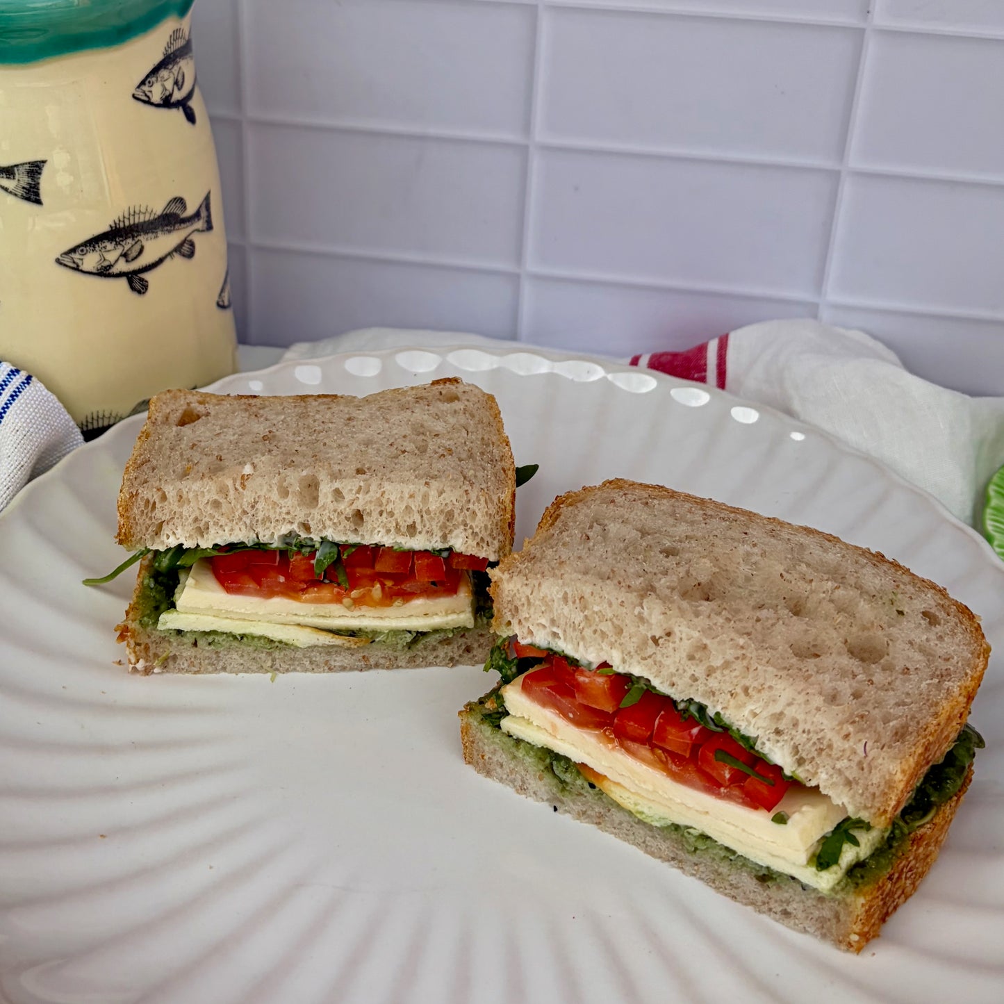 Prosciutto sandwich with pesto, prosciutto, mozzarella, tomatoes + rocket on sourdough