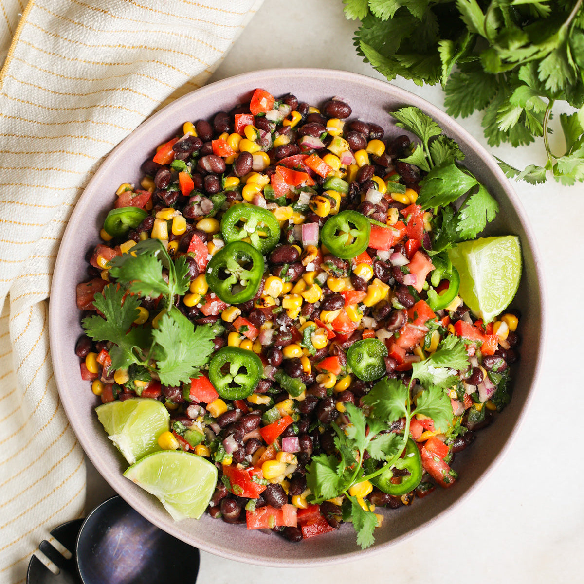 Mexican rice salad with black jasmine rice, black beans, corn, red pepper, baby spinach, avocado, sundried or cherry tomatoes (depending on season), coriander and a zesty lime dressing (gf/vegan)