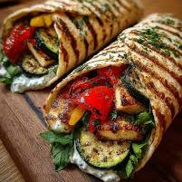 Grilled zucchini + halloumi wraps with grilled zucchini, halloumi, red pepper, cucumber + tzatziki (vegetarian)
